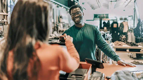 Man giving card to cashier.
