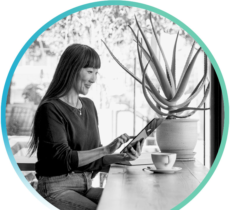 woman drinking tea and reading news on a tablet