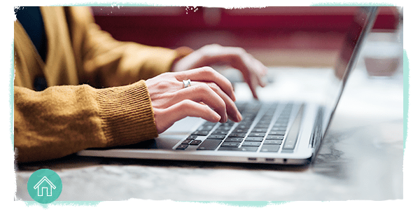 hands typing on a laptop keyboard