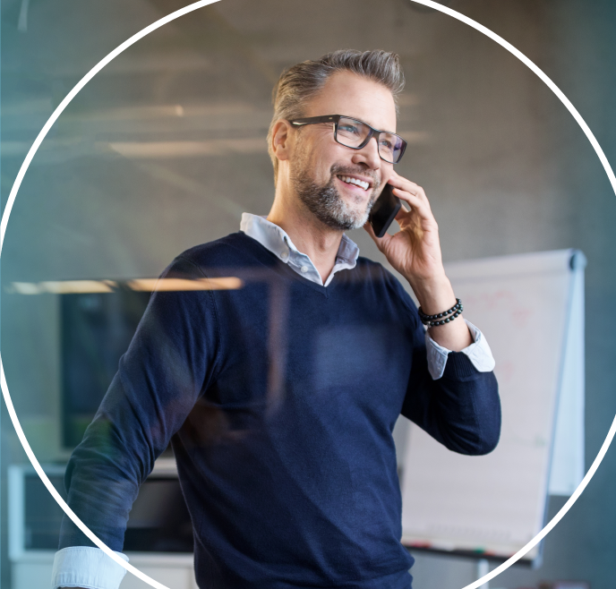 Man wearing blue sweater talking on the phone