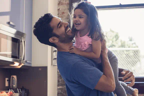 Dad picking up daughter