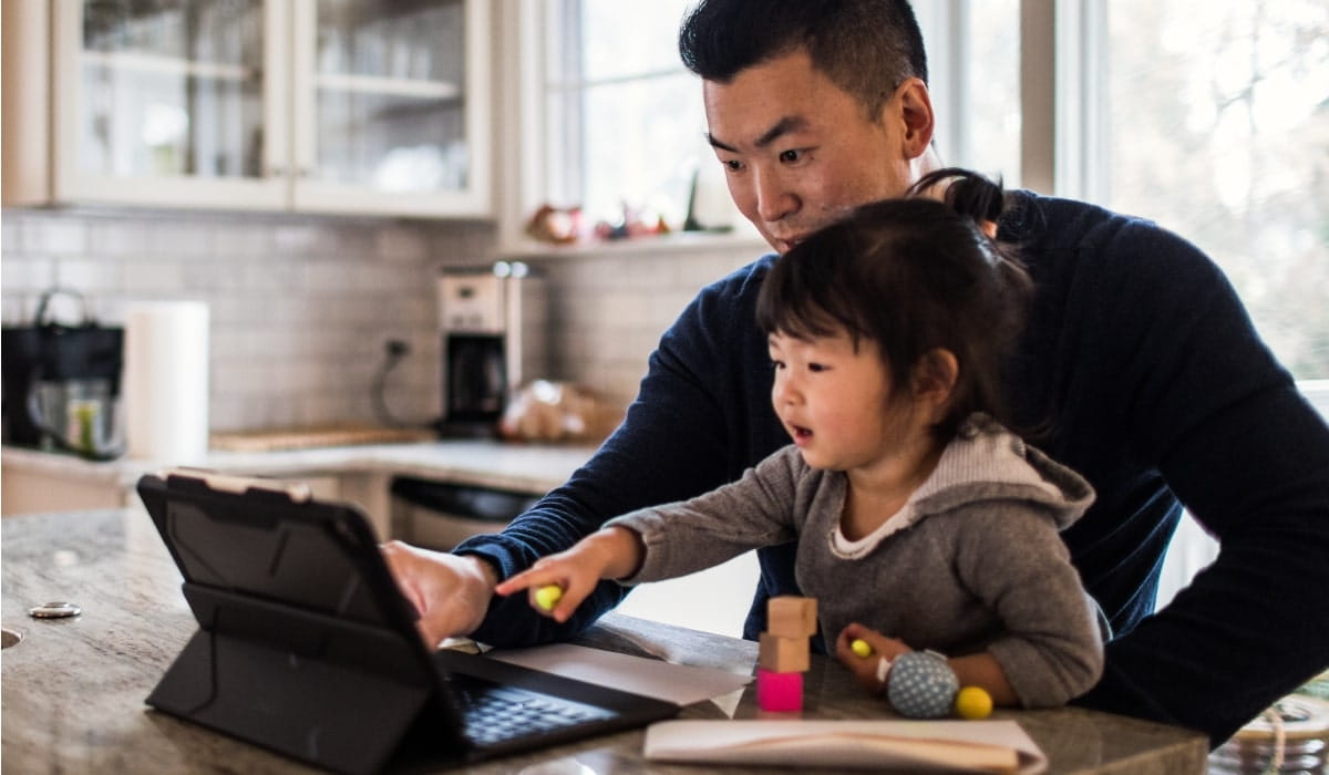 Dan working on laptop with child