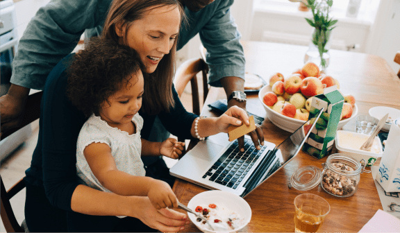 family looking at laptop