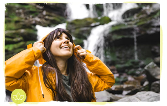 Smiling woman near waterfall