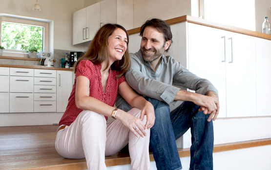 couple smiling in new kitchen