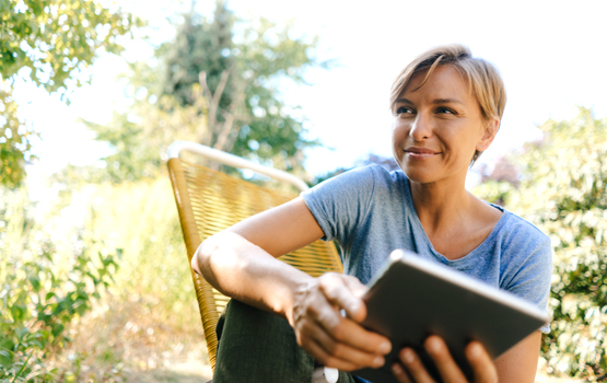 woman smiling and holding a notebook