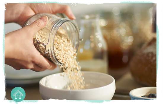 Person pouring grain from a jar into a bowl