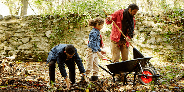 Man and his children clearing the debris