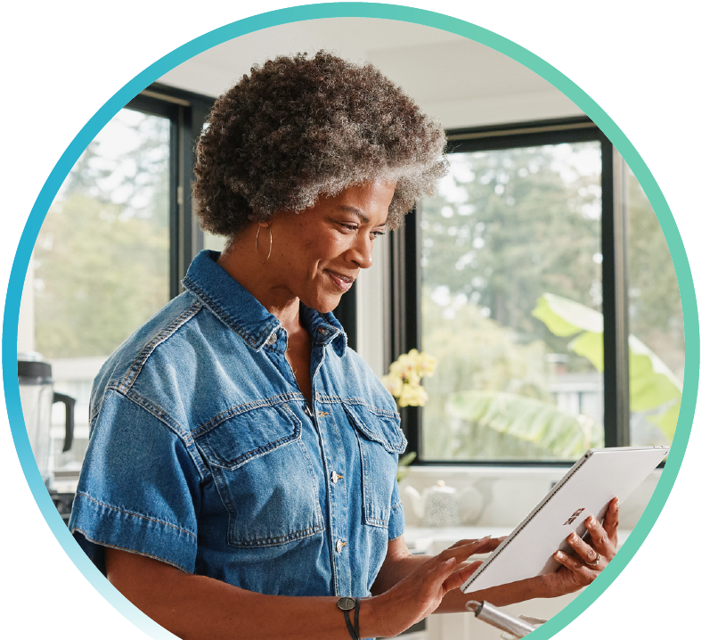 Image of a woman browsing on a tablet in the kitchen.