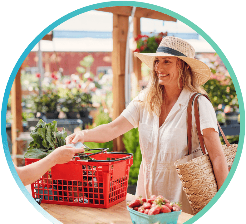 Woman handing a First Tech Platinum Secured credit card to a cashier at a flower boutique.