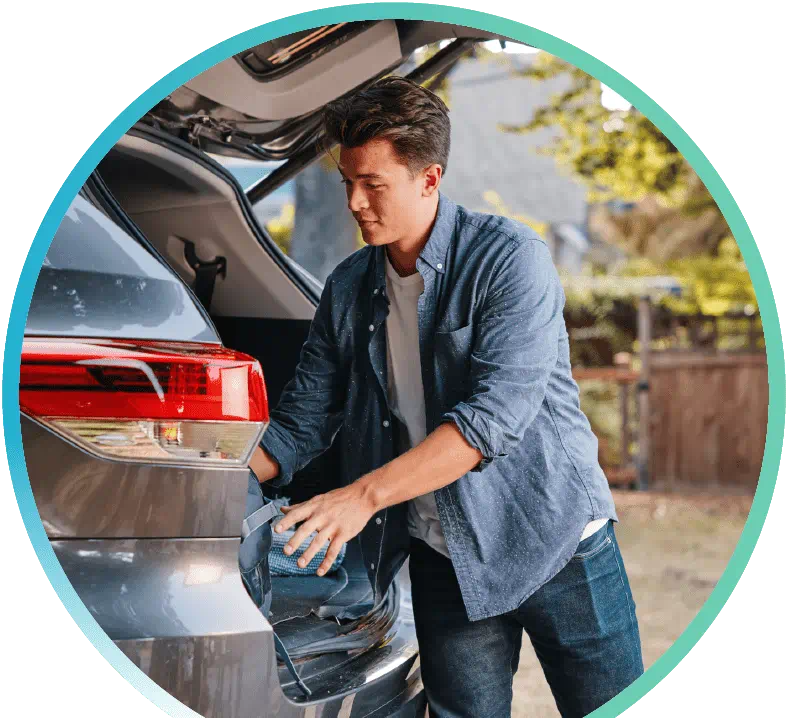 Man unloading the trunk of their SUV.