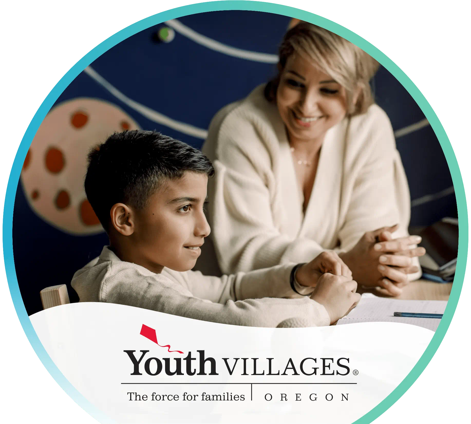 Child and adult sitting at a table with a pencil and paper in front of them. Youth Villages logo in the foreground.