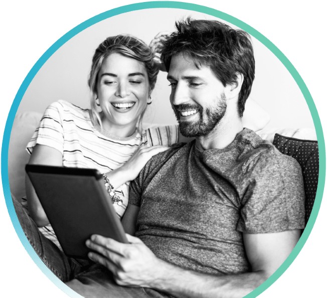 smiling man and woman looking at a tablet