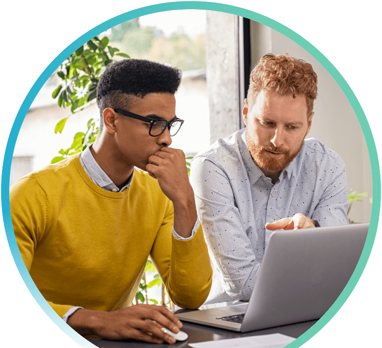 Two men working on a laptop