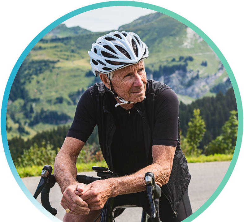 Man wearing a helmet and sitting on a bike.