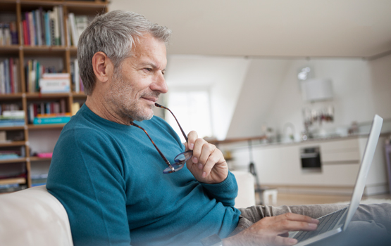 Man sitting on couch with a laptop