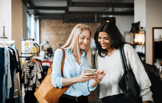 Women shopping and using mobile phone