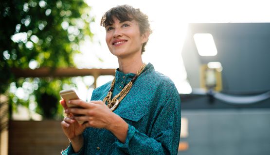 Woman standing outside using her phone